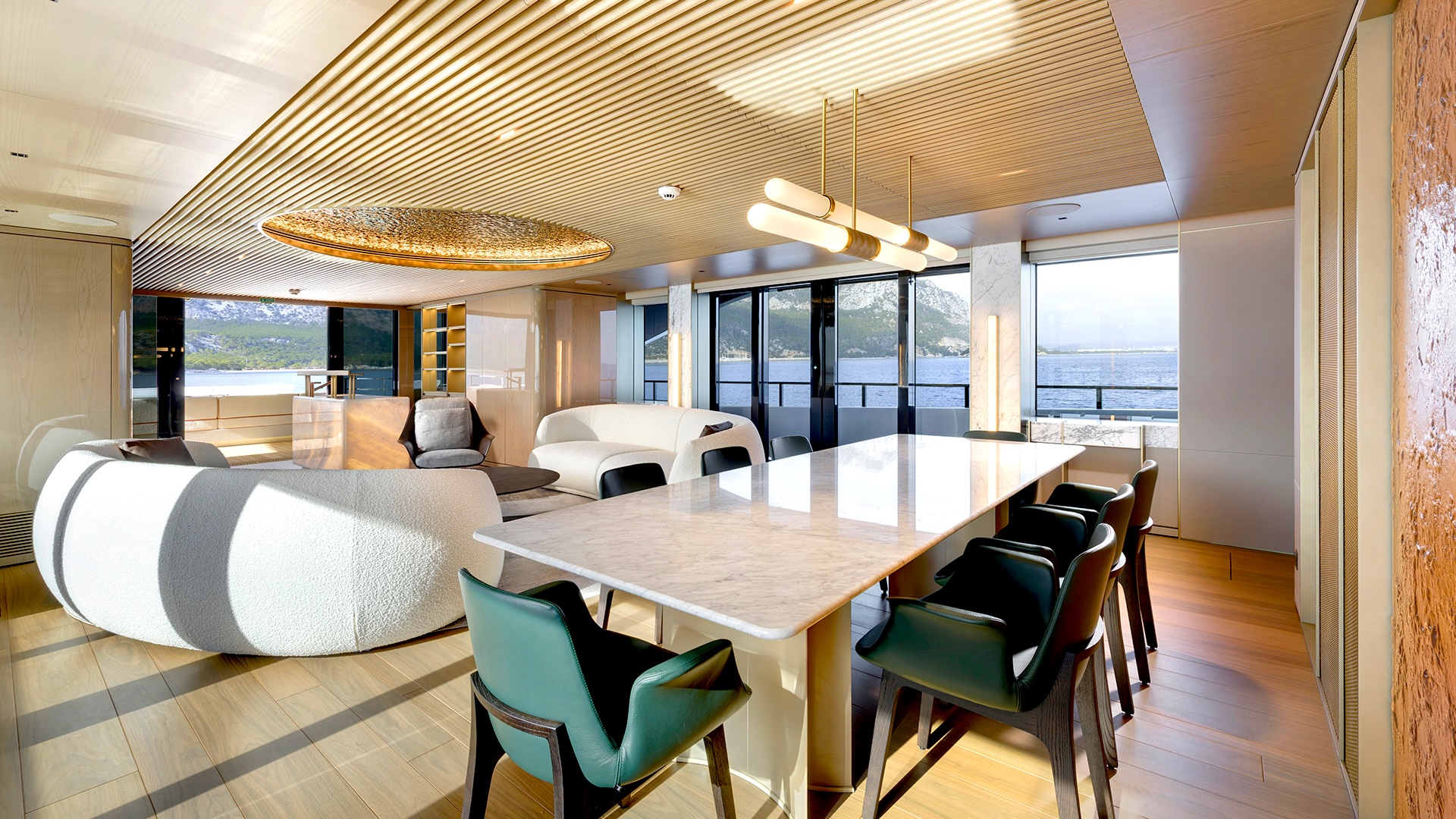 Dining area of the Alia 43M, centered on a marble table with curved seating