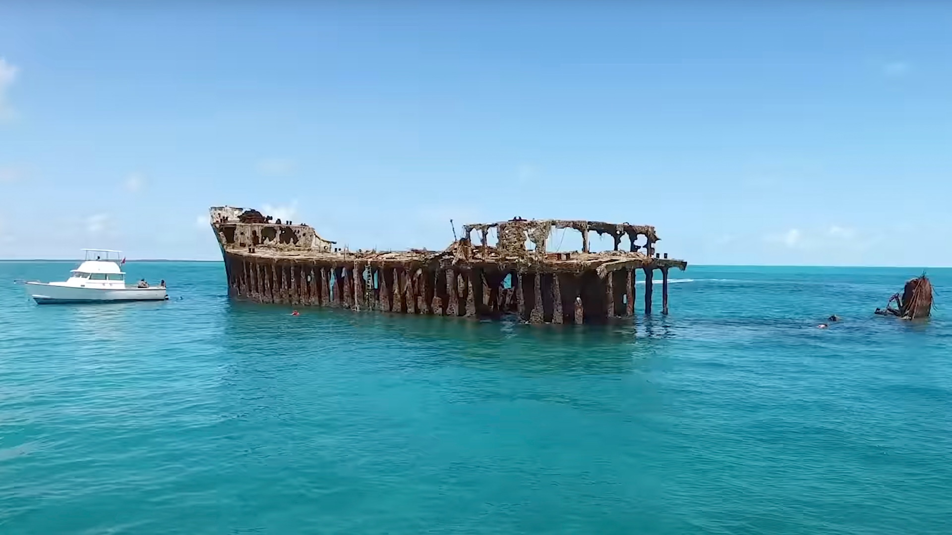 The wreck of the SS Sapona standing partly above the surface in shallow Bahamian water