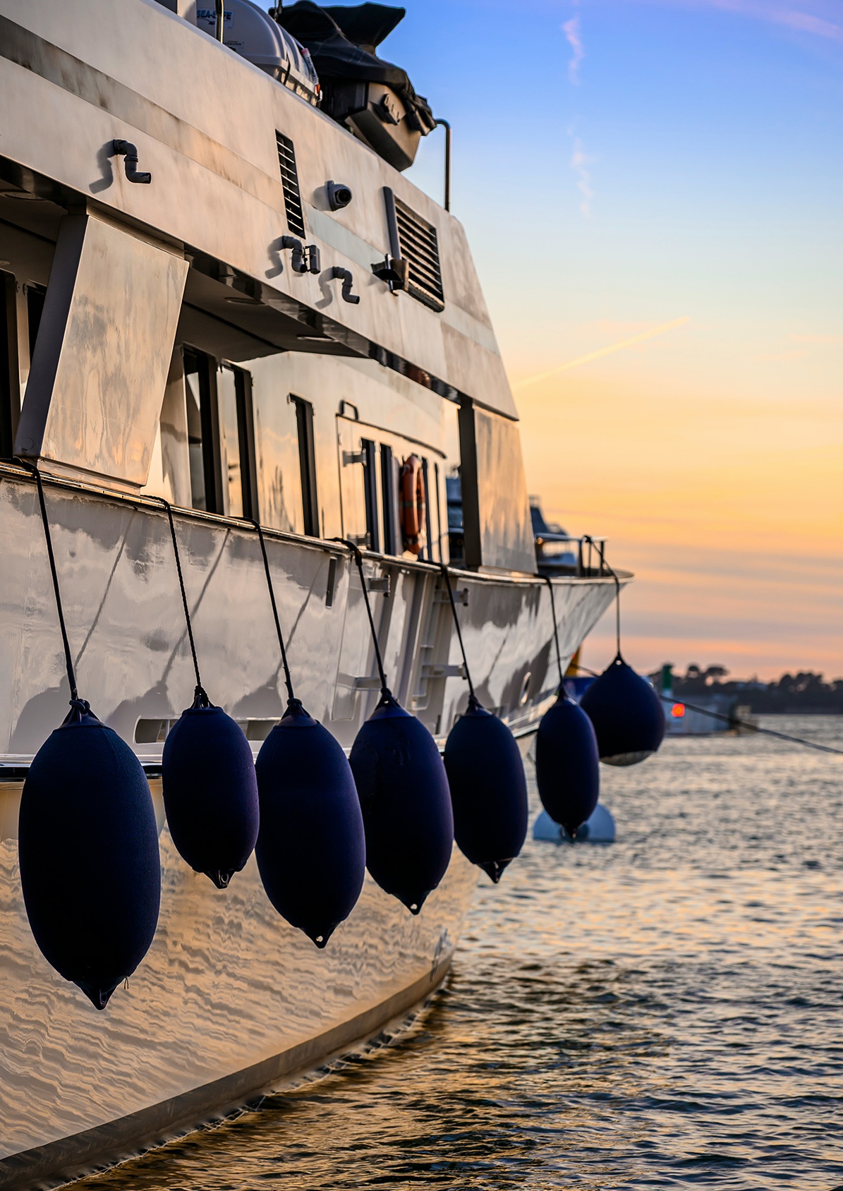 Fenders hanging from the side of a yacht