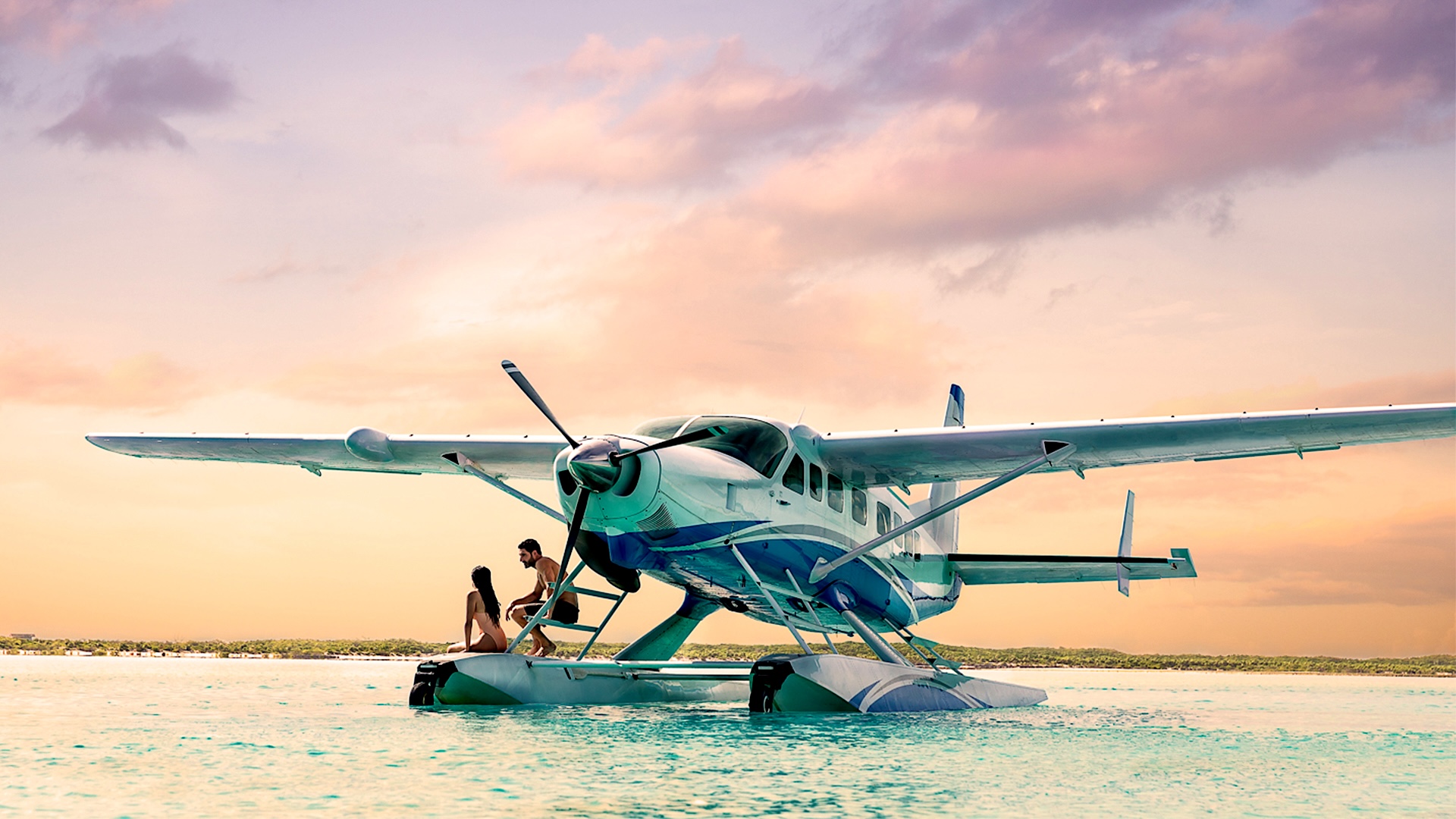 A seaplane resting on shallow turquoise water at dusk in the Exumas