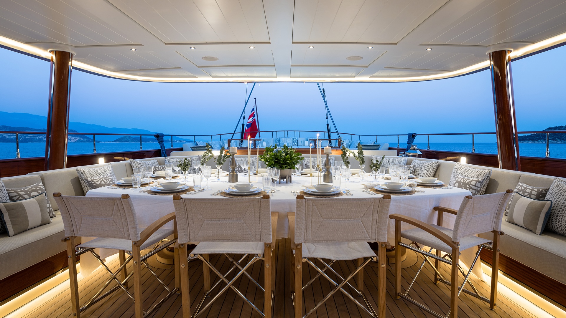 Outdoor dining on Simena's aft cockpit with mahogany tables