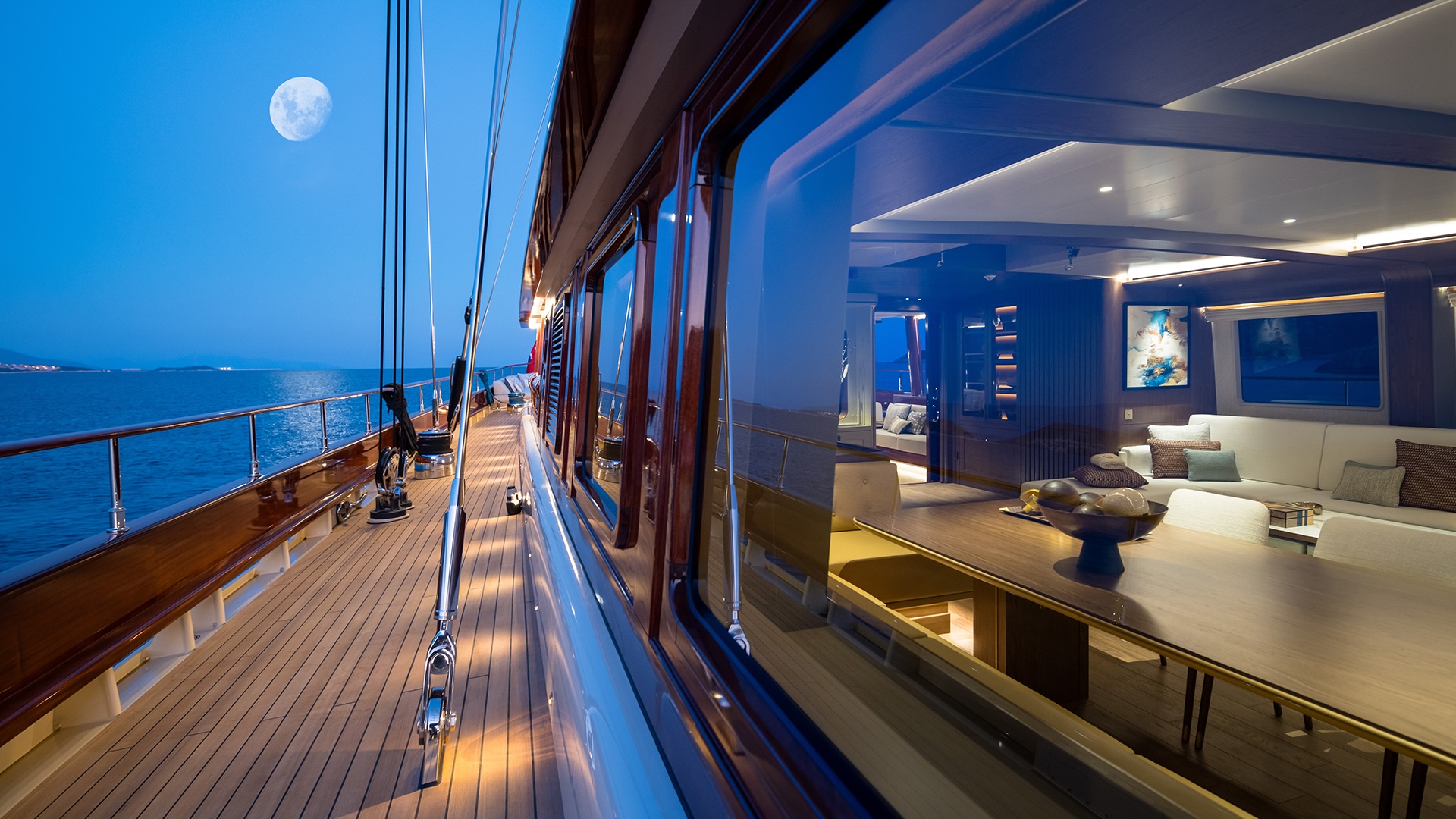 Wide side deck on the ARES Simena 62m sailing yacht with the moon at the horizon