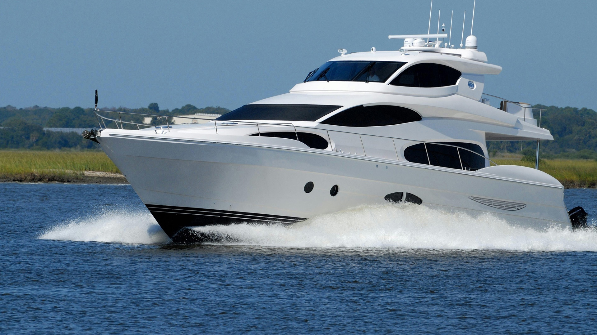 A planing motorboat traveling at speed through a narrow channel, generating a large stern wake