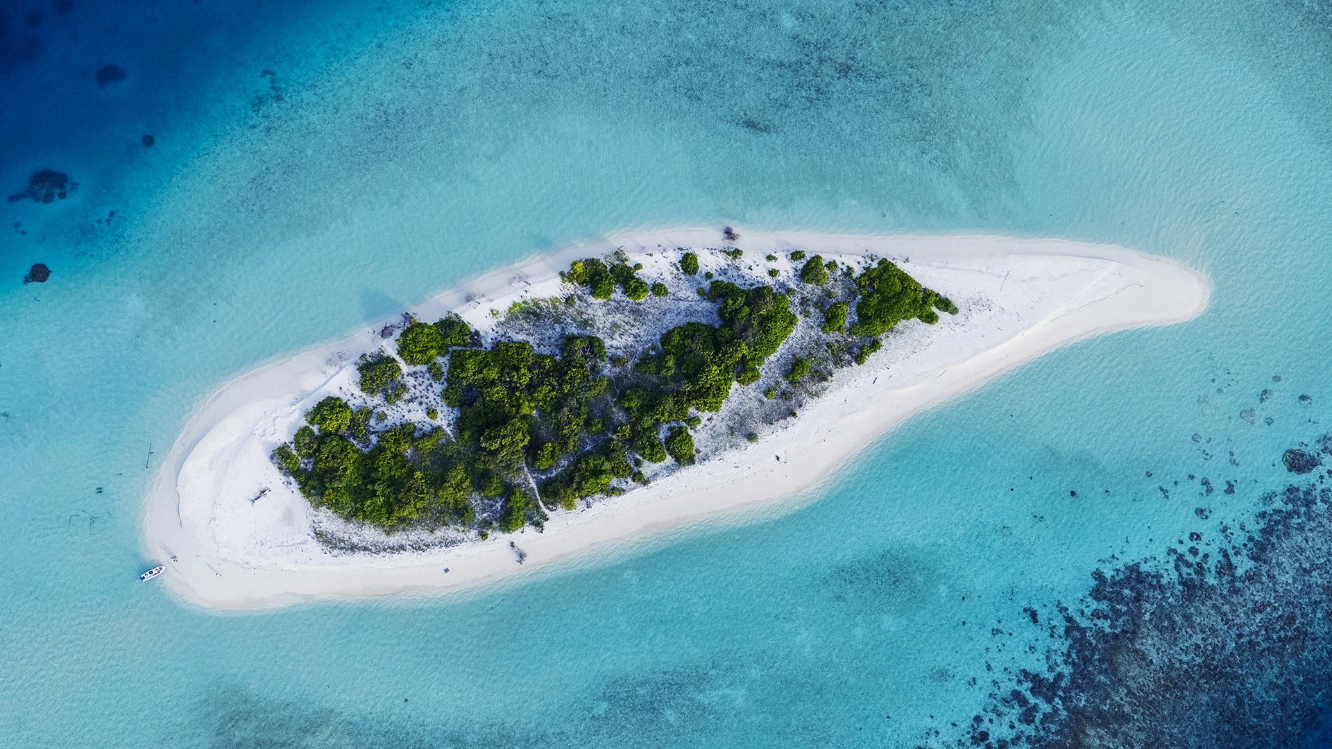 Drone view of a small private island in turquoise waters