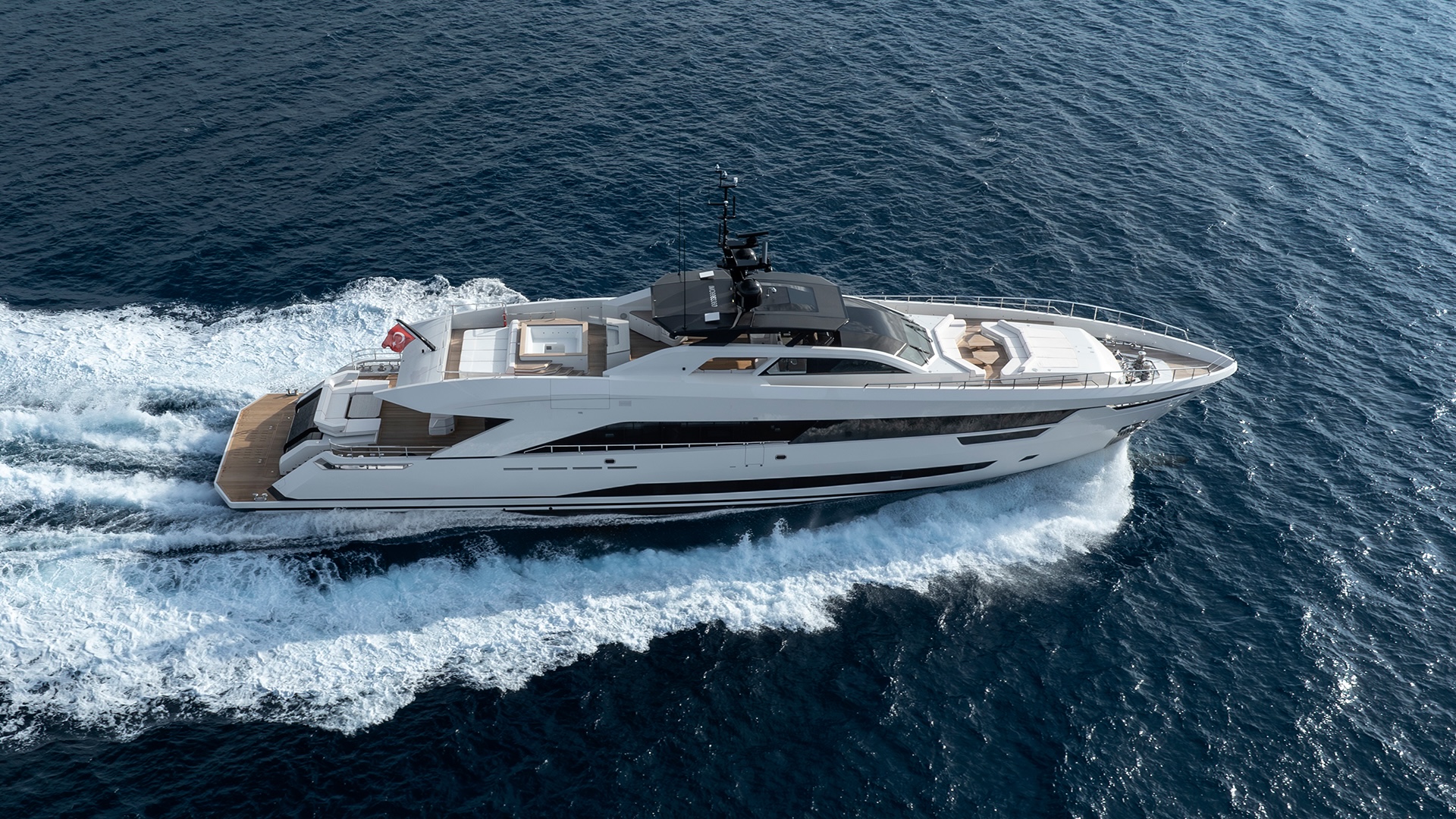 Aerial view of the Alia 43M underway, showing the full sundeck under the black hardtop