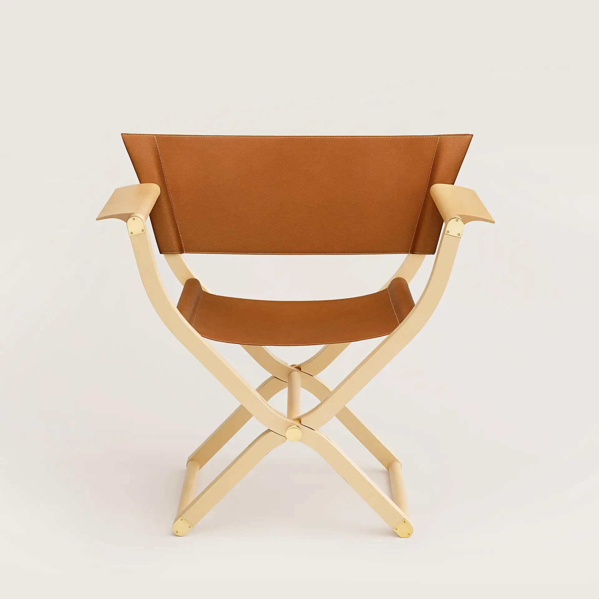 Pippa folding armchair, full view, photographed against a beige ground.