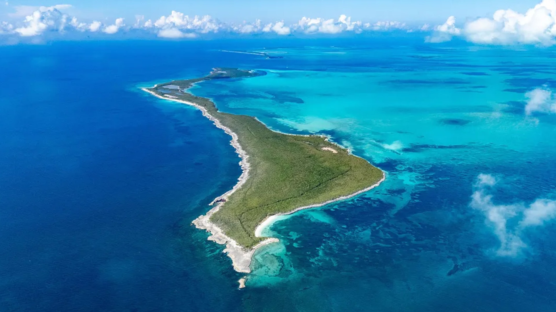 An aerial view of one of the Berry Islands surrounded by clear water