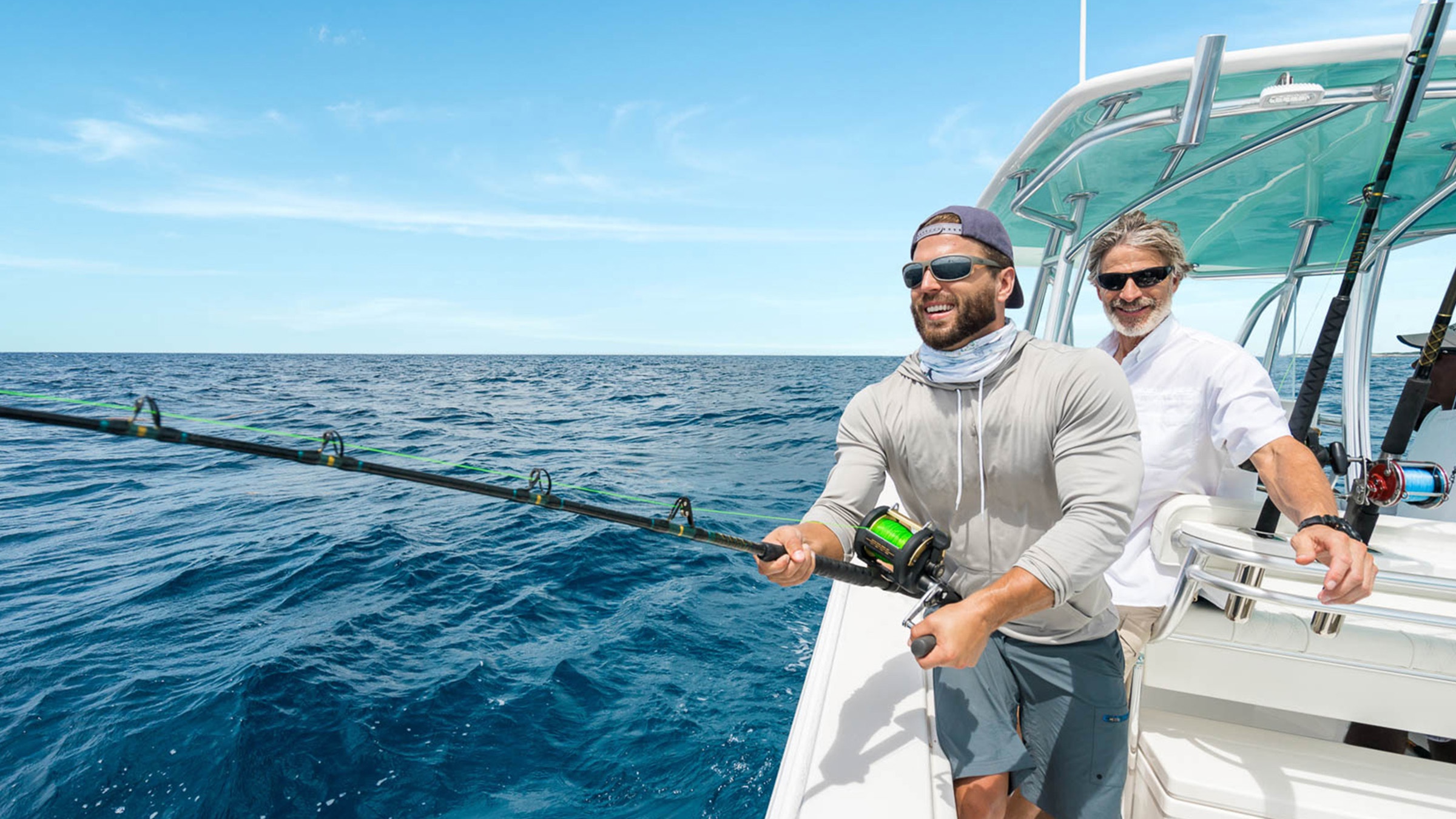 Two anglers fishing from a small boat on open water