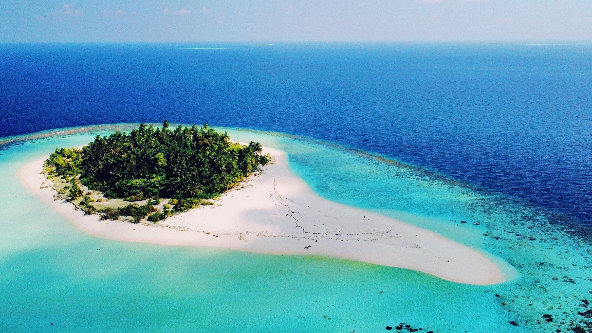 Aerial study of a private island in clear water