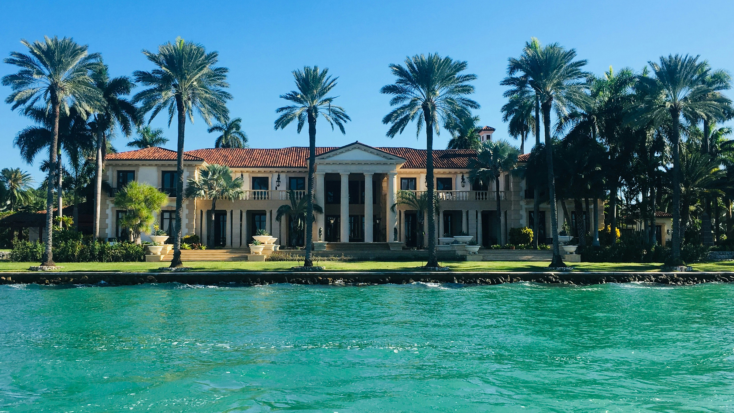 European-style residence viewed from the turquoise water of the bay