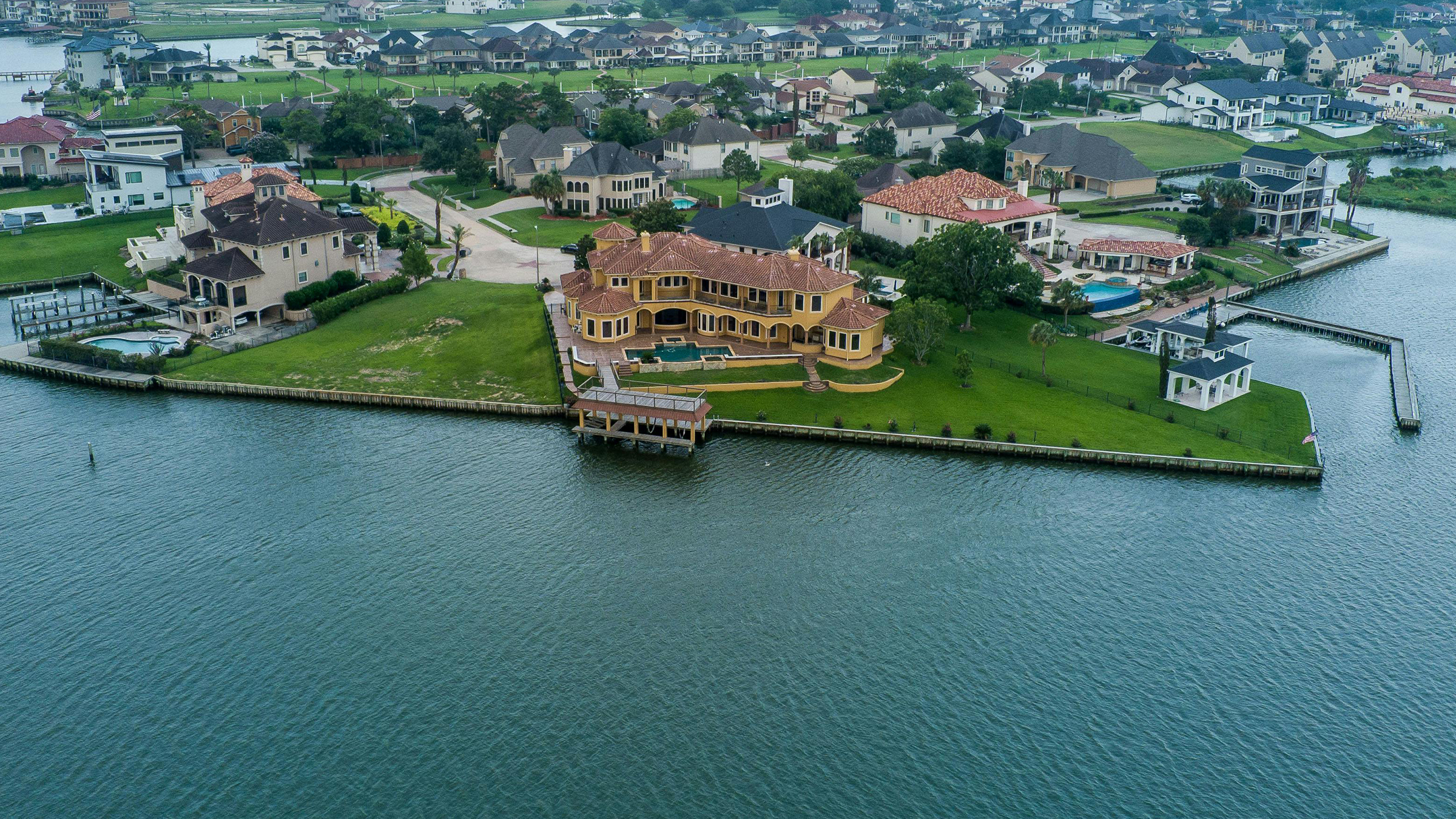 Aerial view of a waterfront community with private docks