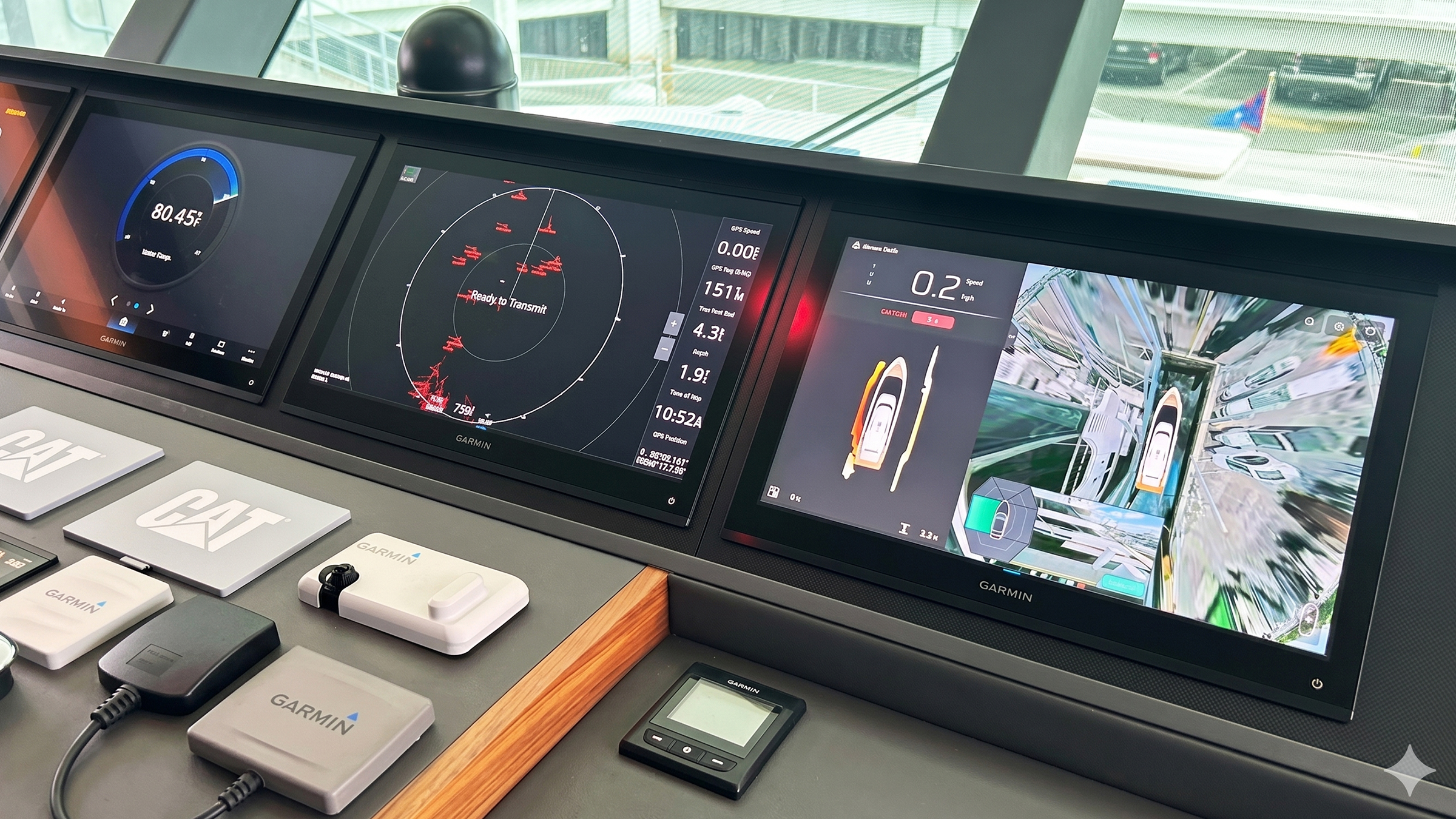 A yacht helm with three multifunction displays, one of them showing a docking assistant interface