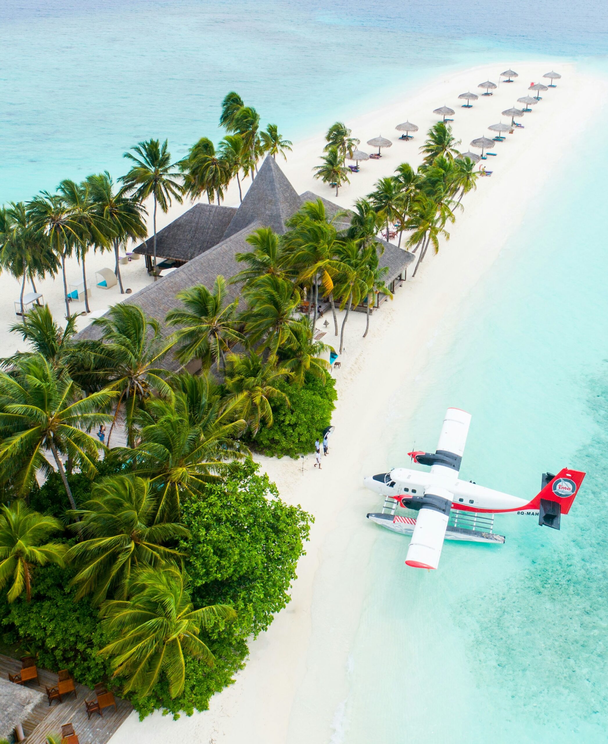 Drone view of a house on a private island with a seaplane at the dock