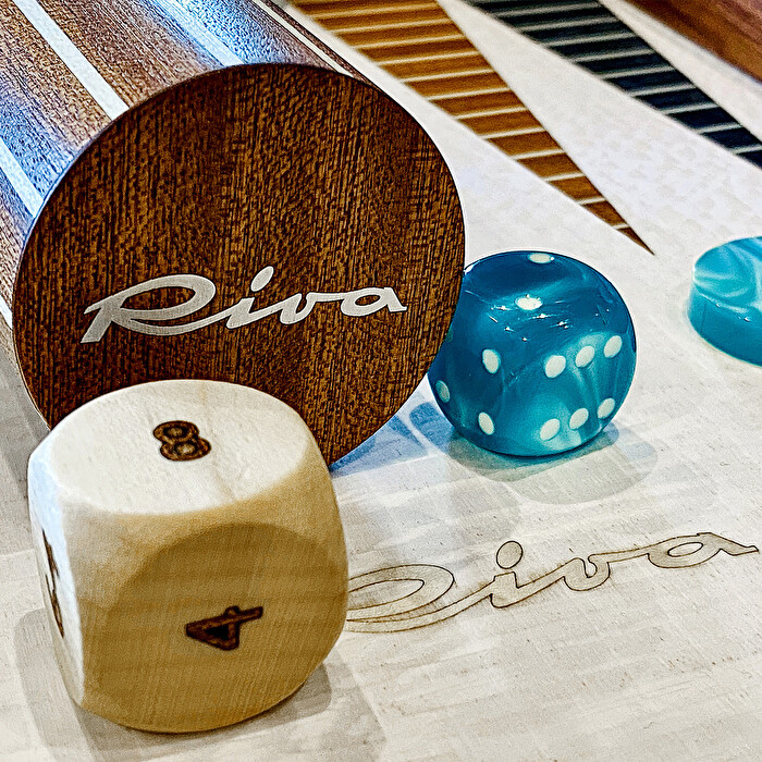 Macro detail of a playing piece and the dice, mahogany inlay visible.