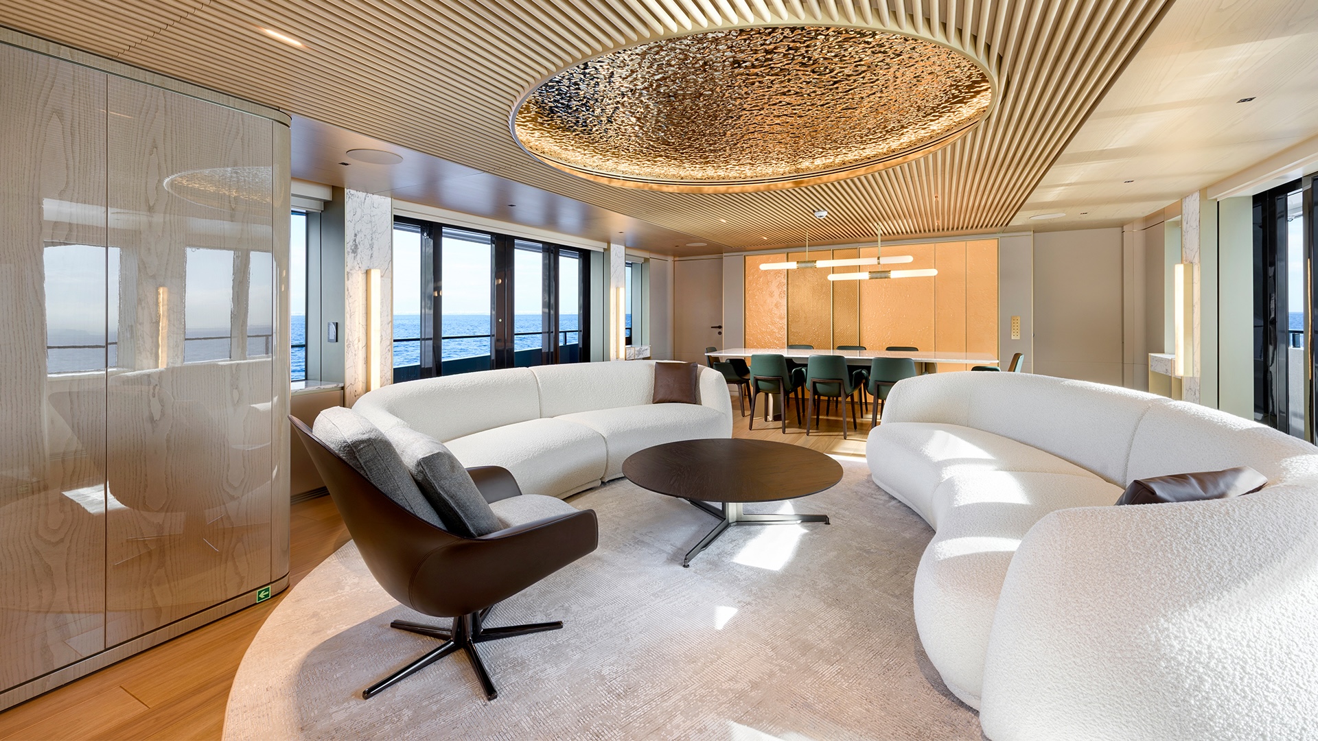 Main saloon of the Alia 43M, with curved seating, an onyx bar element and a wavy glass ceiling feature