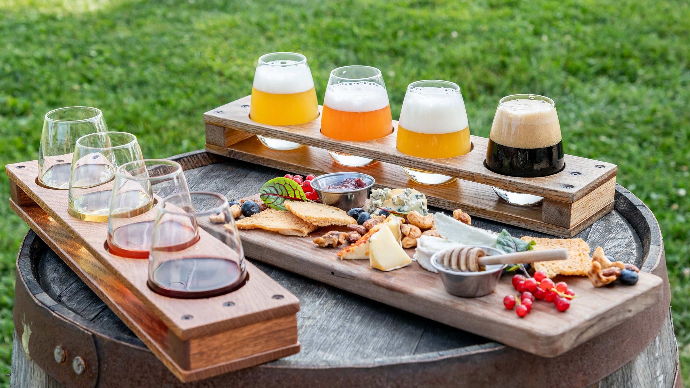Tasting trays of beer, wine and appetizers on a rustic barrel
