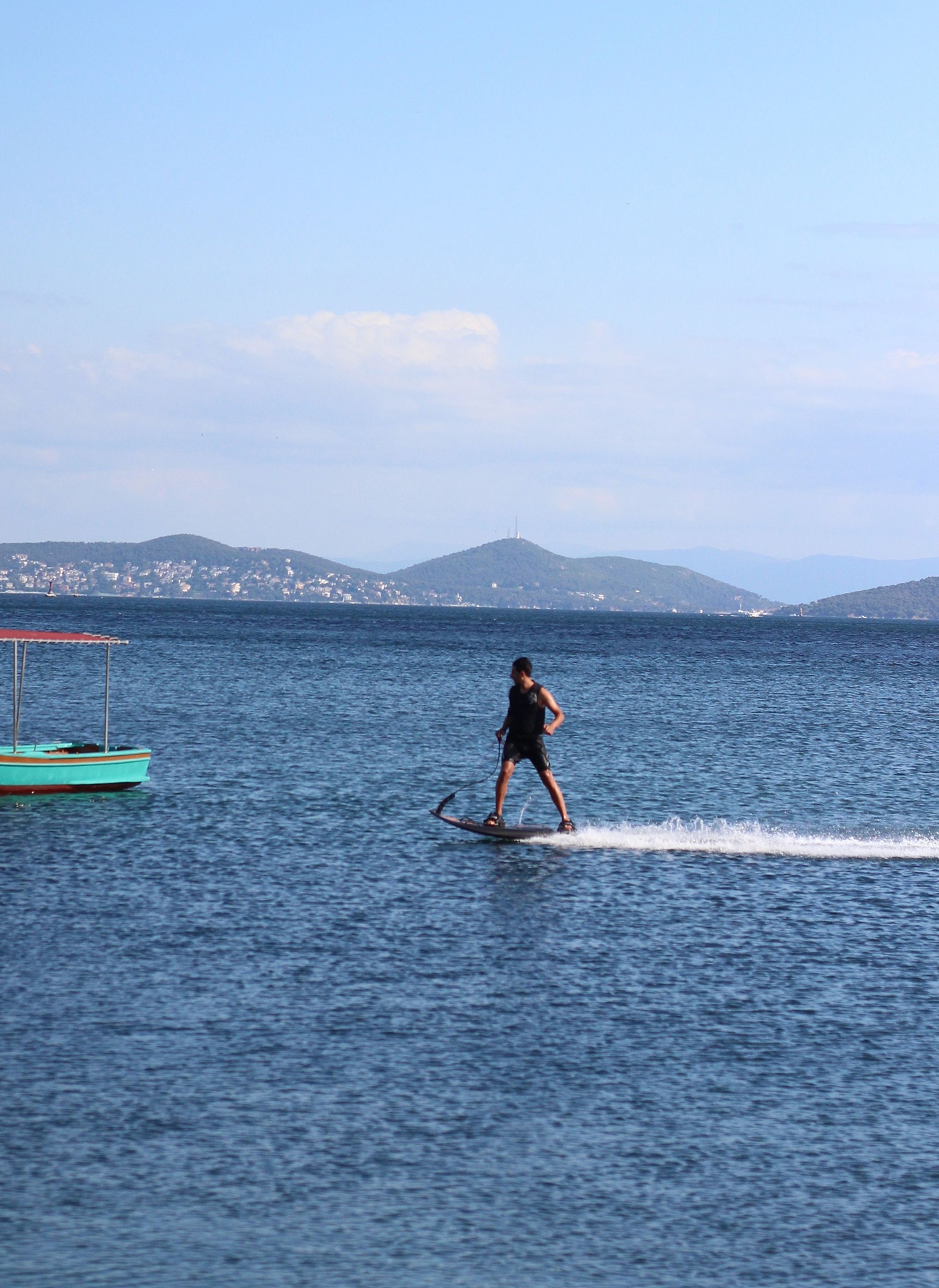 A rider on an electric surfboard