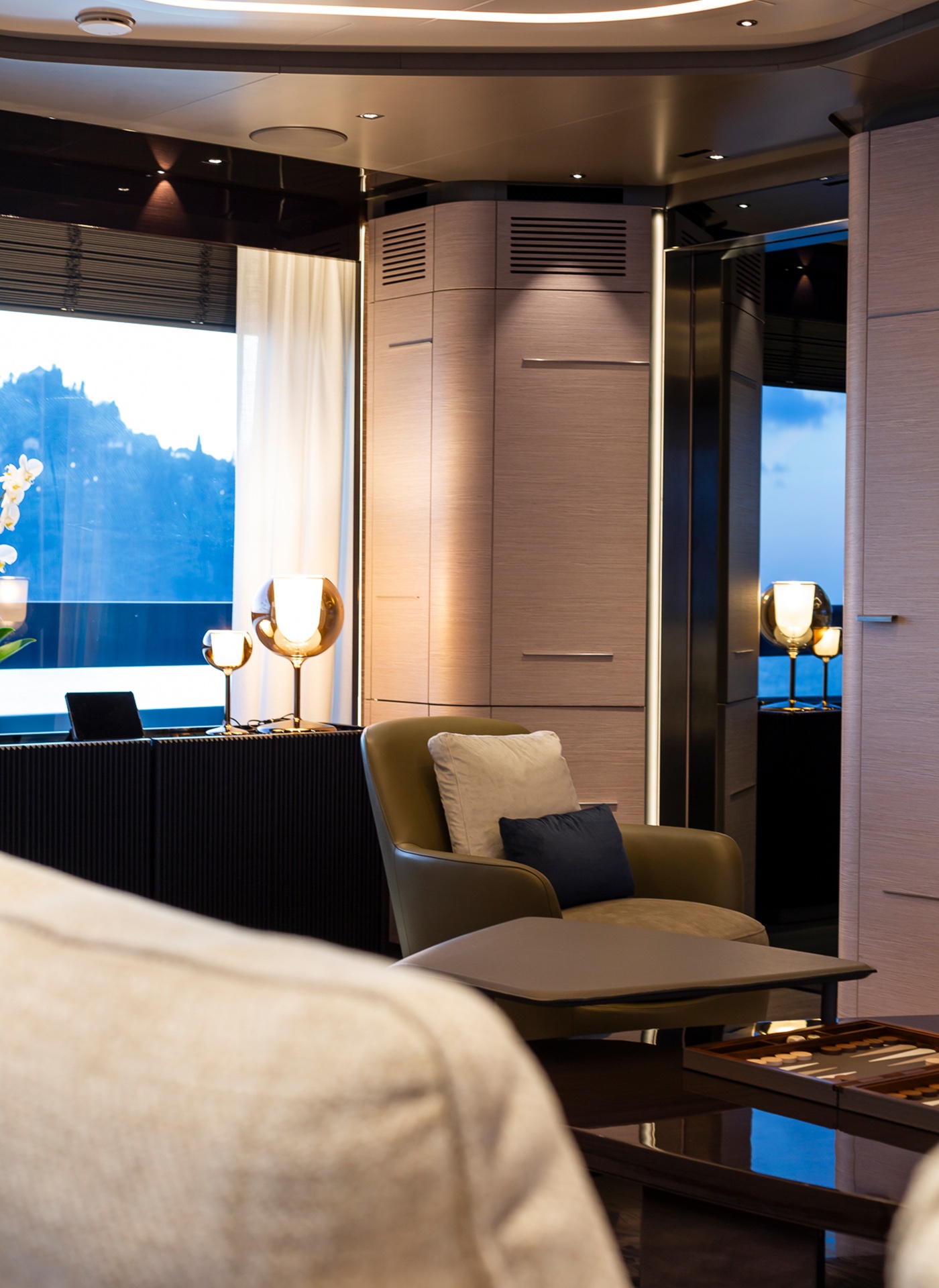 A bright saloon with a sofa and a low table set with a backgammon board