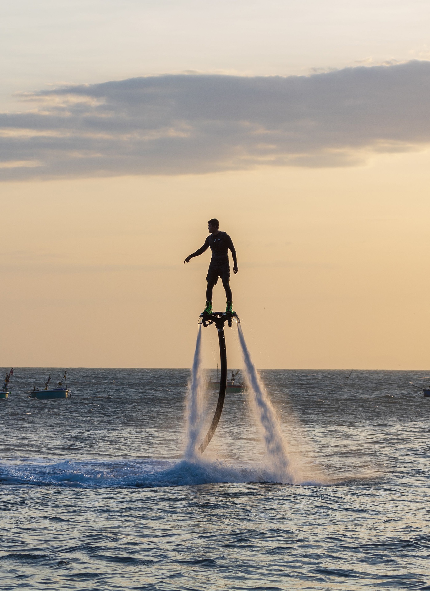 A rider on a flyboard lifted above the water