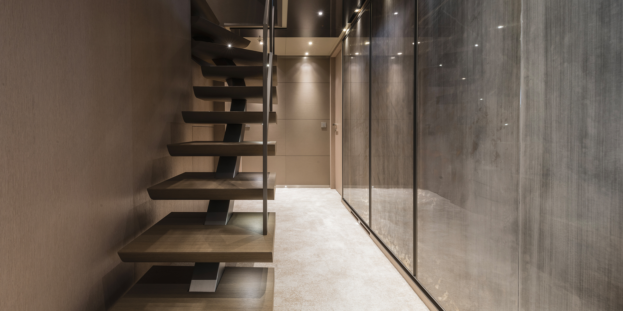 Yacht interior passage with staircase in refined materials