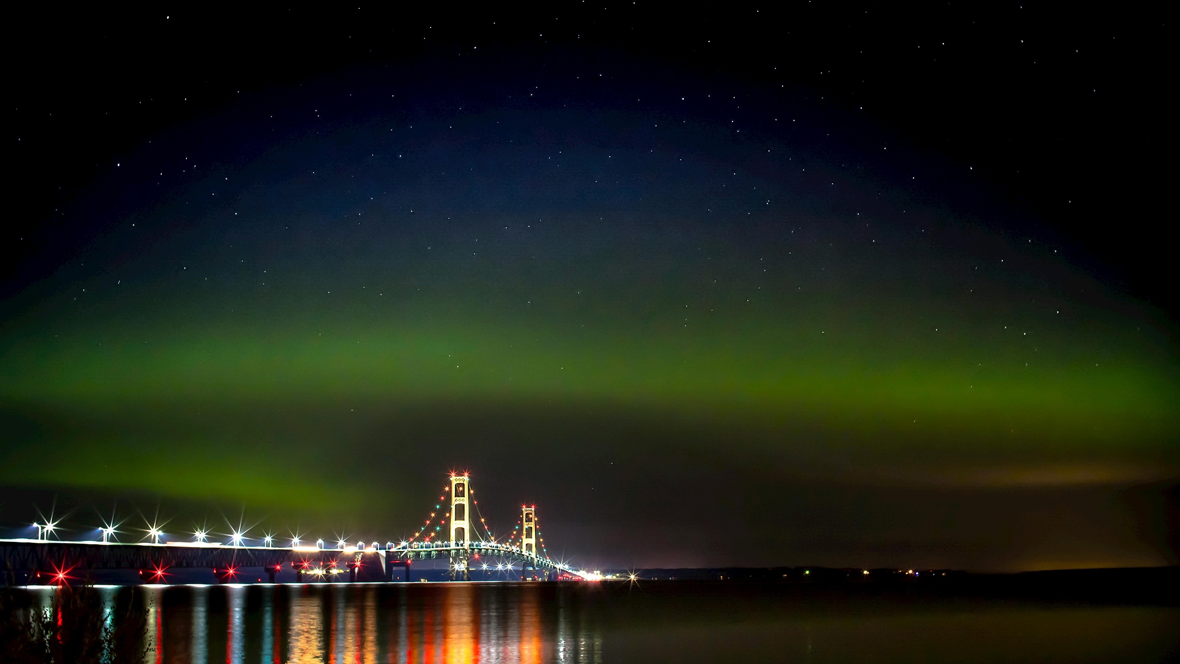 Northern lights over the Mackinac Bridge, Michigan, against a starry sky