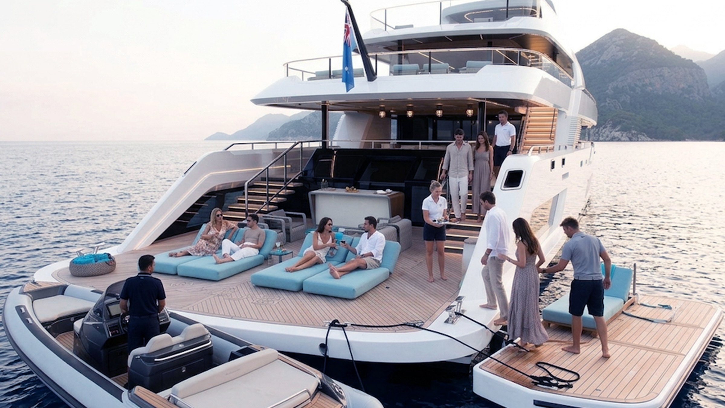 Crew welcoming guests from the stern of a superyacht