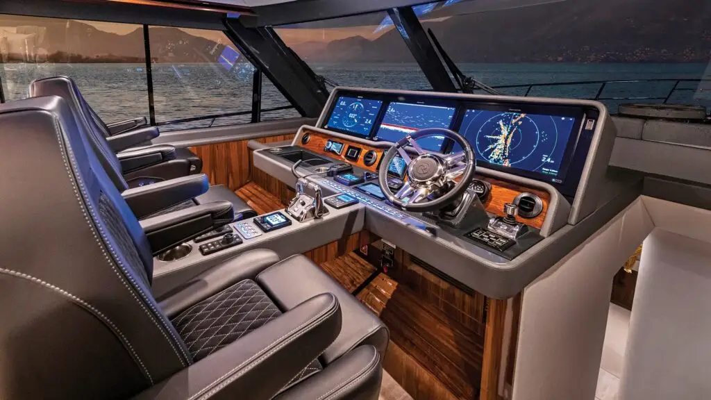 2400 x 1350 HERO Impactante helm interior de un riviera 645, con 3 displays, sonar, radar, gps joystic y mas controles, Imagen al atardecer con el helm muy iluminado