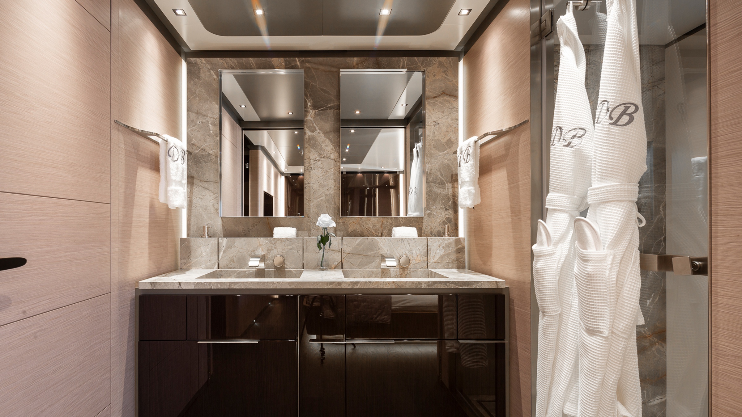 An ensuite bathroom with two robes by the shower door