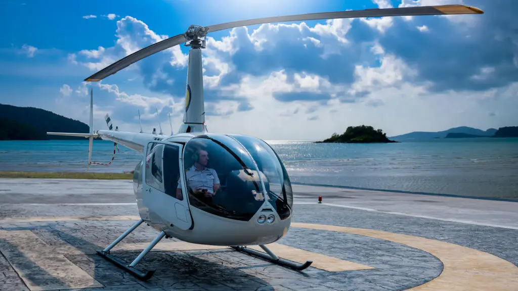 2400 x 1350 helicopter ready for landing with coastal beside on tropical