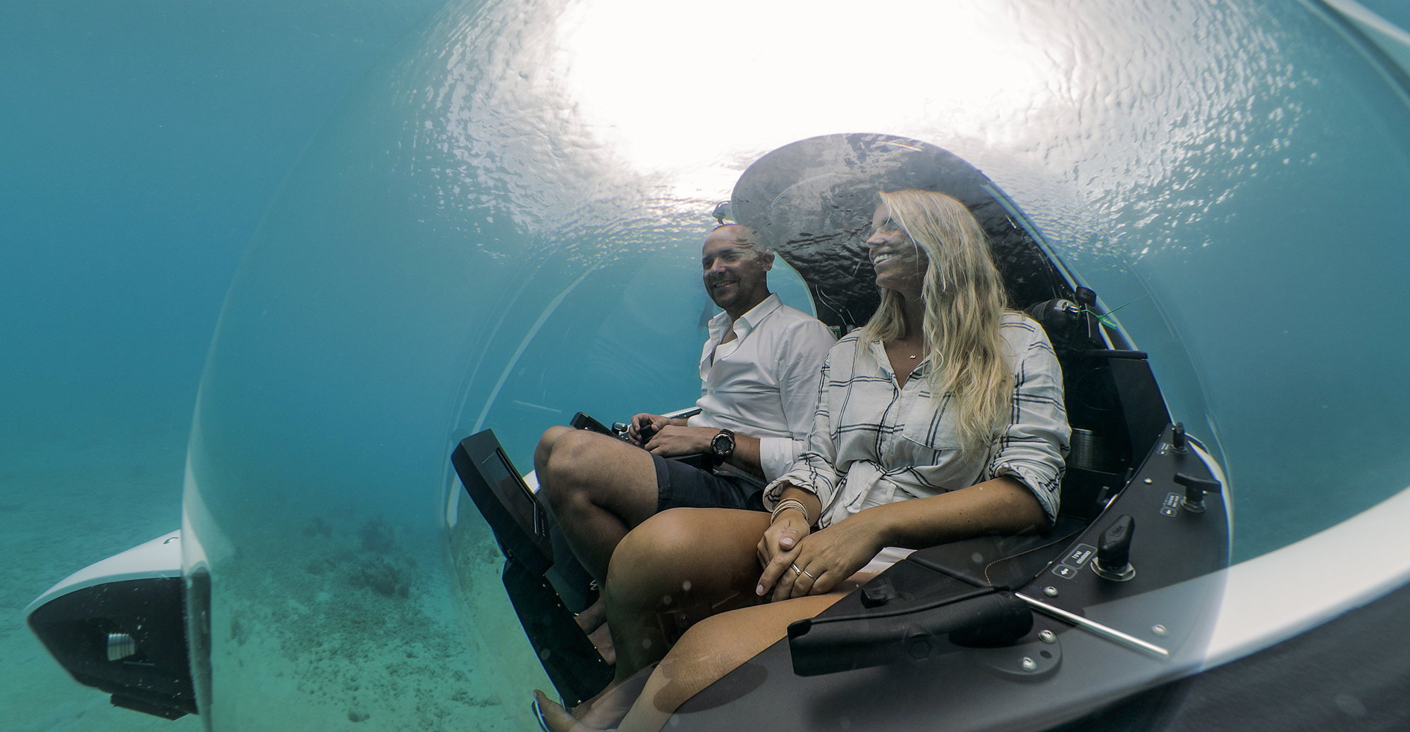 A couple enjoying the dive inside a submersible