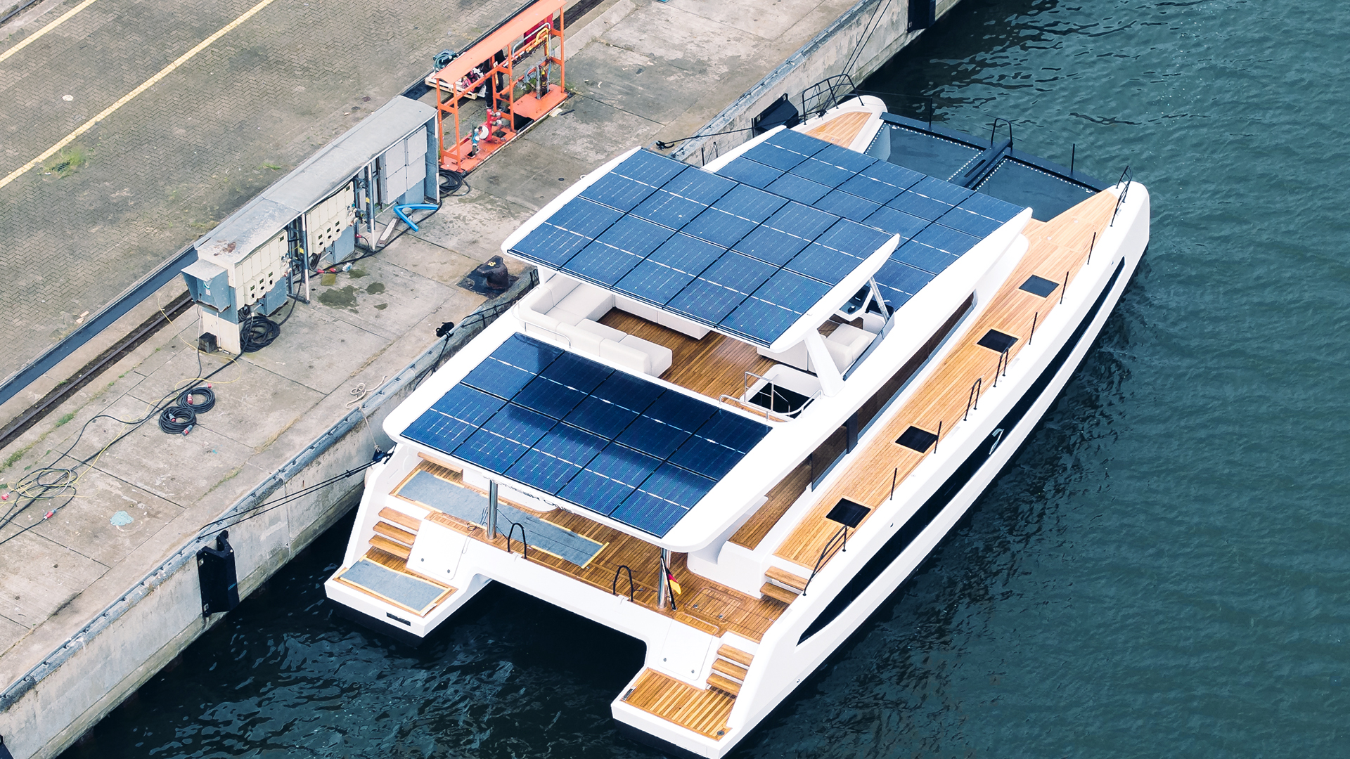 Aerial view of the catamaran showing the solar panels covering its horizontal surfaces
