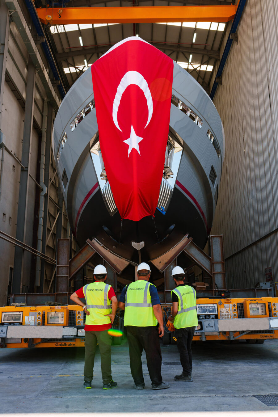 Head on view of the yacht's plumb bow as she leaves the shipyard hall for her launch