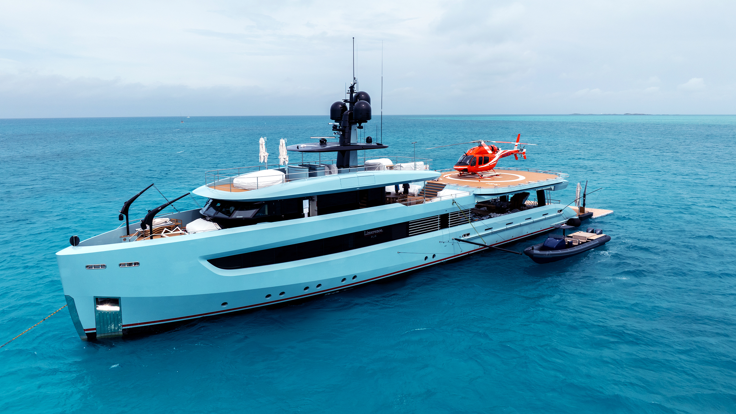 Limerence at anchor with helicopter and tender alongside