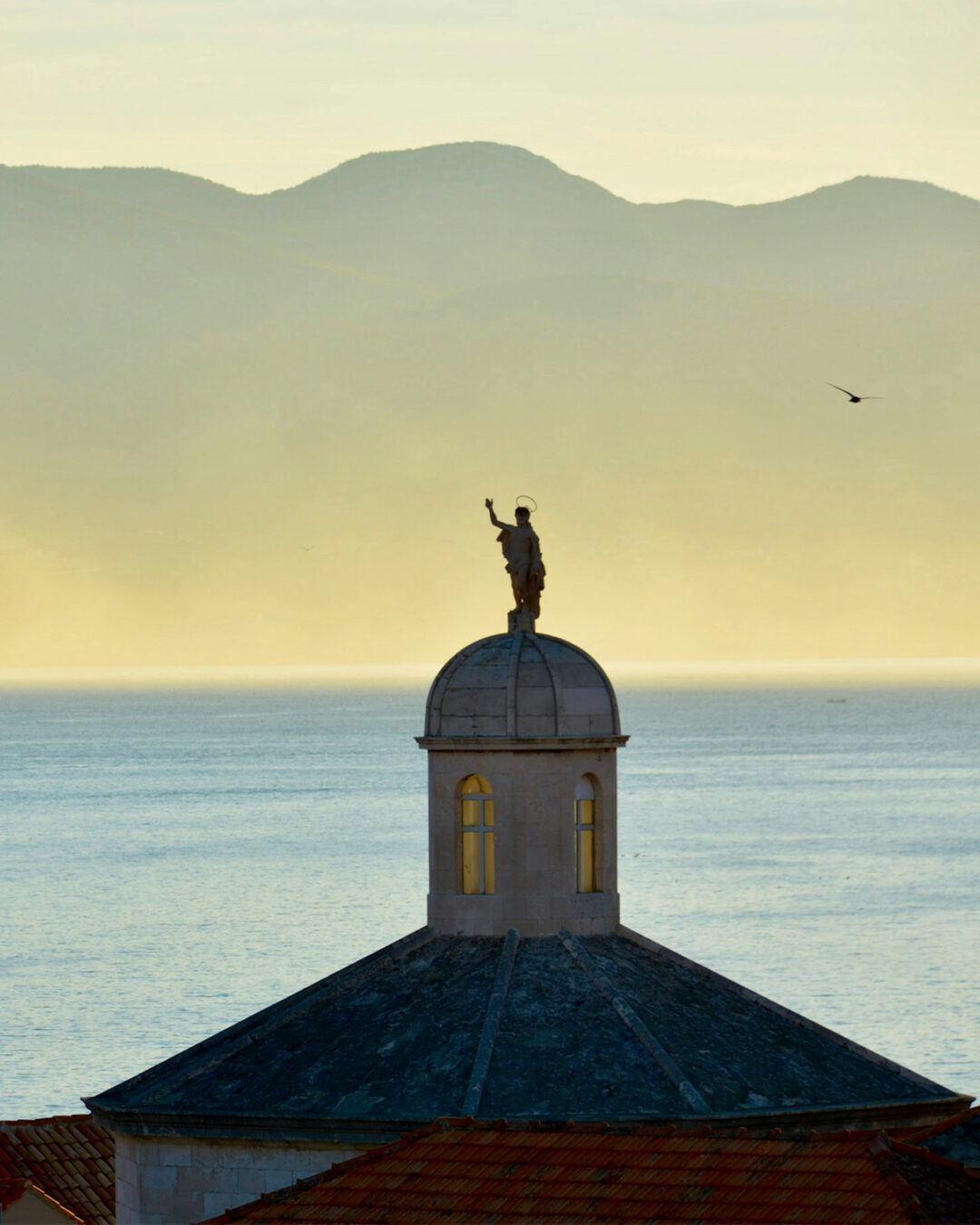 Korčula at sunset, a domed church against the sea