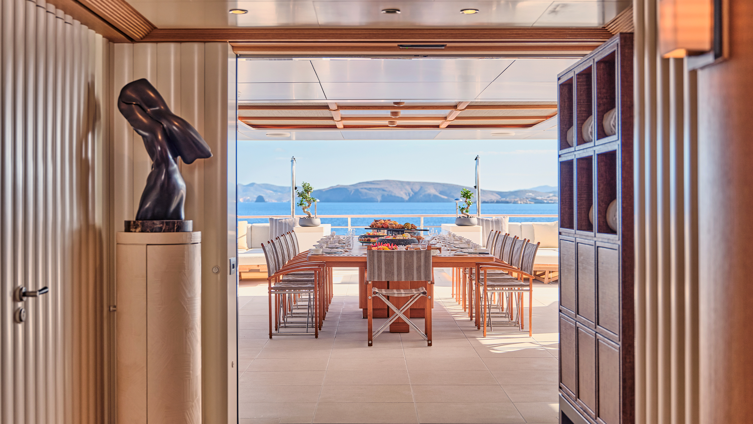 The aft deck table set for lunch, seen from the saloon