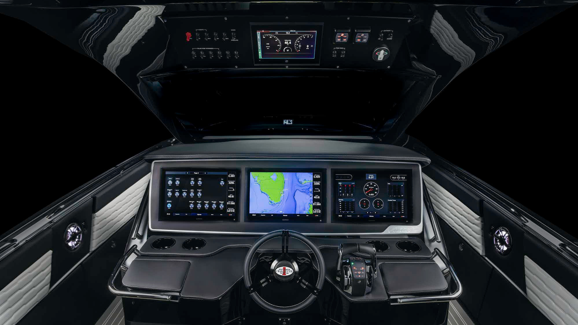 Black helm station with three navigation screens and a sport steering wheel
