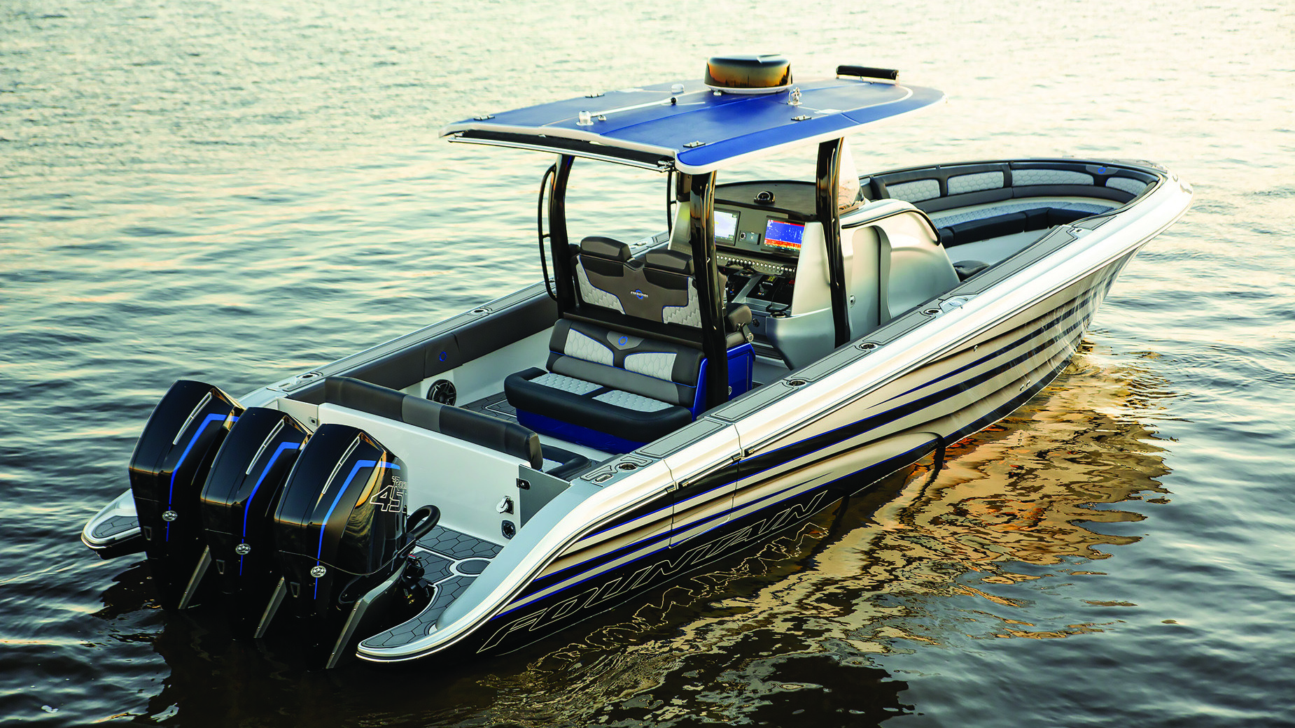 Sport center console boat with a blue T-top and three outboard engines on calm water