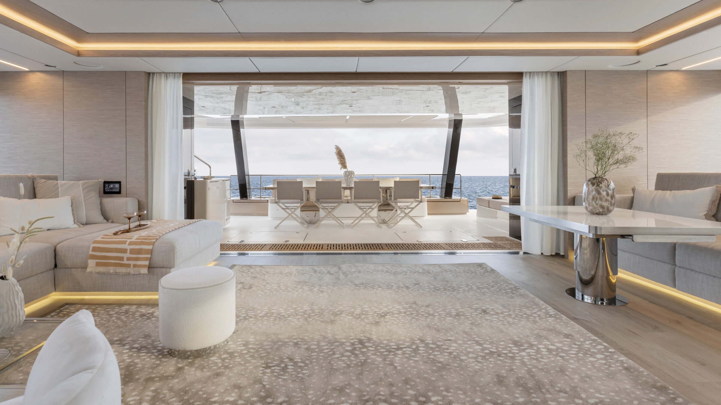 Main salon of the 80 Sunreef Power Eco open to the aft dining area, with the sea beyond