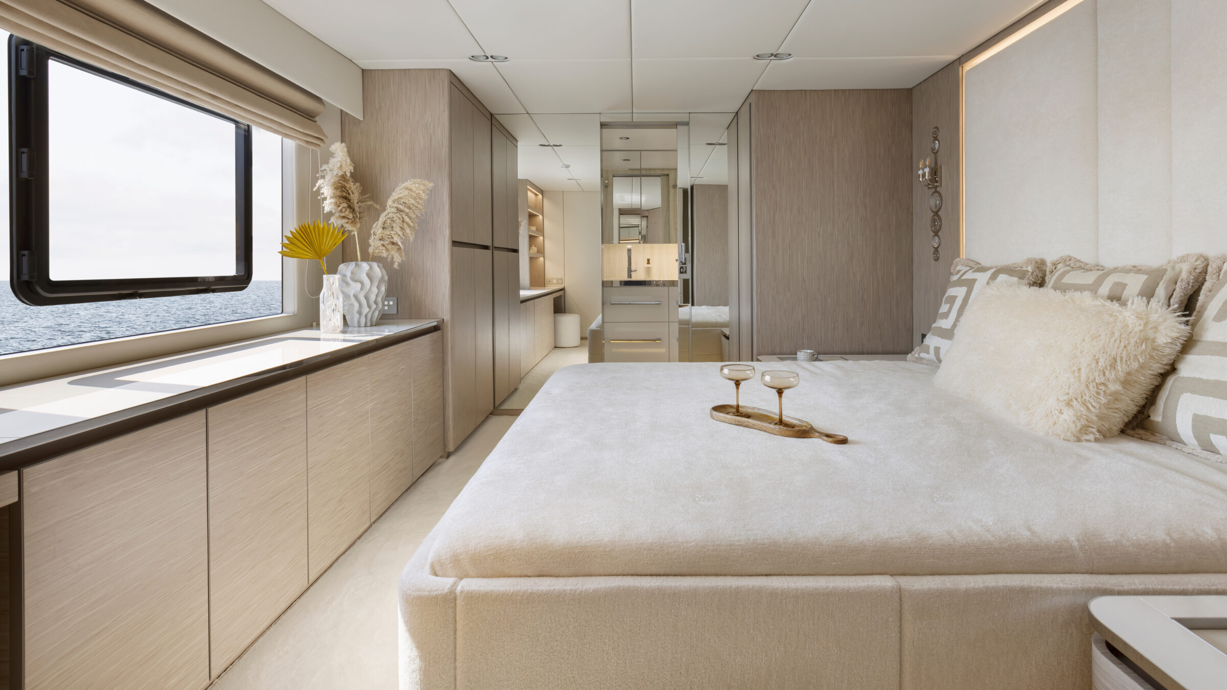 Cabin on the 80 Sunreef Power Eco with double bed, light finishes and a window to the sea