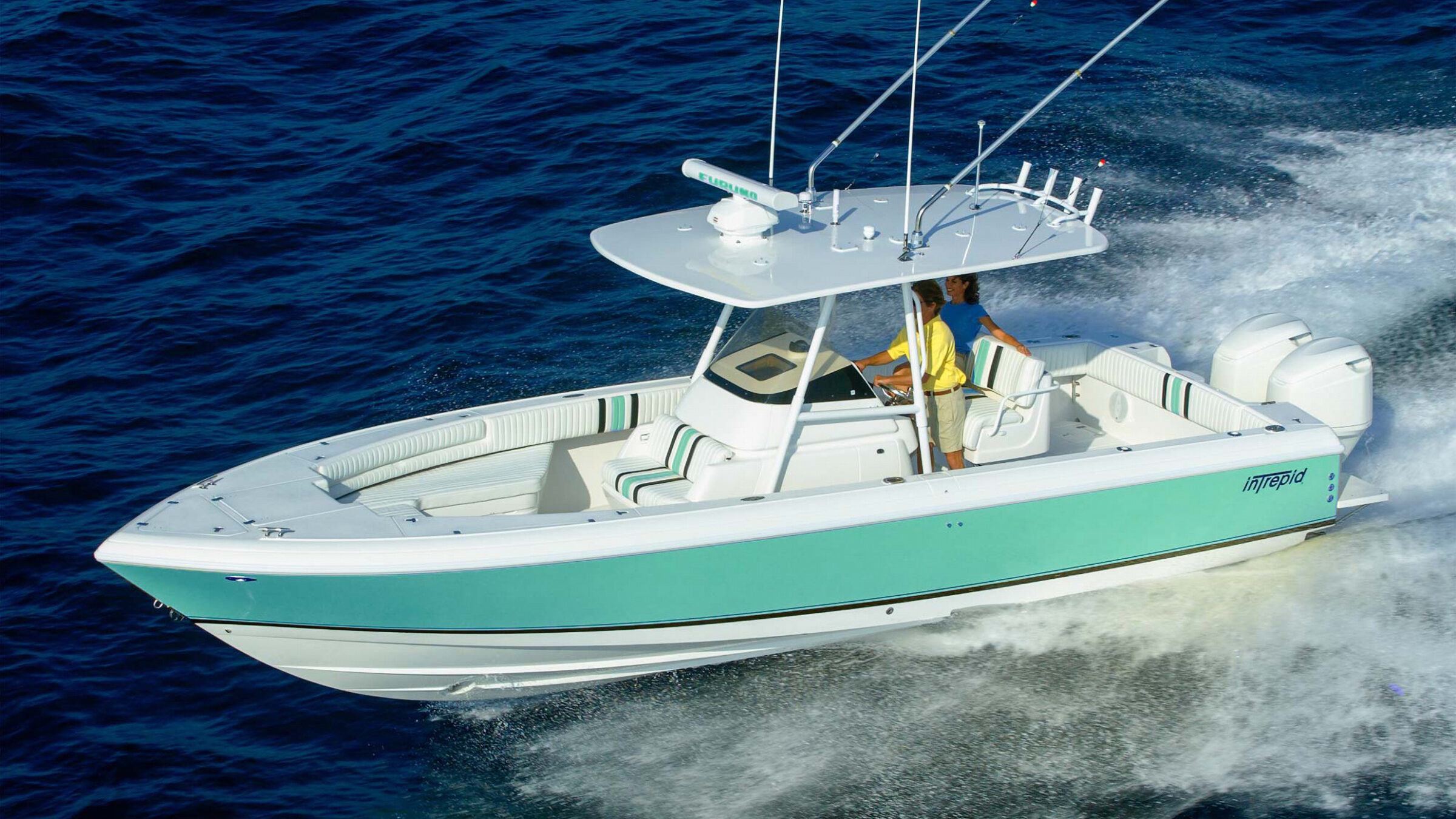 Fishing boat with a seafoam green hull and center console running at speed in open sea